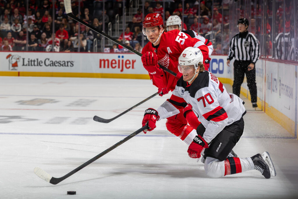 Devils beat Red Wings in OT as Hughes stars
